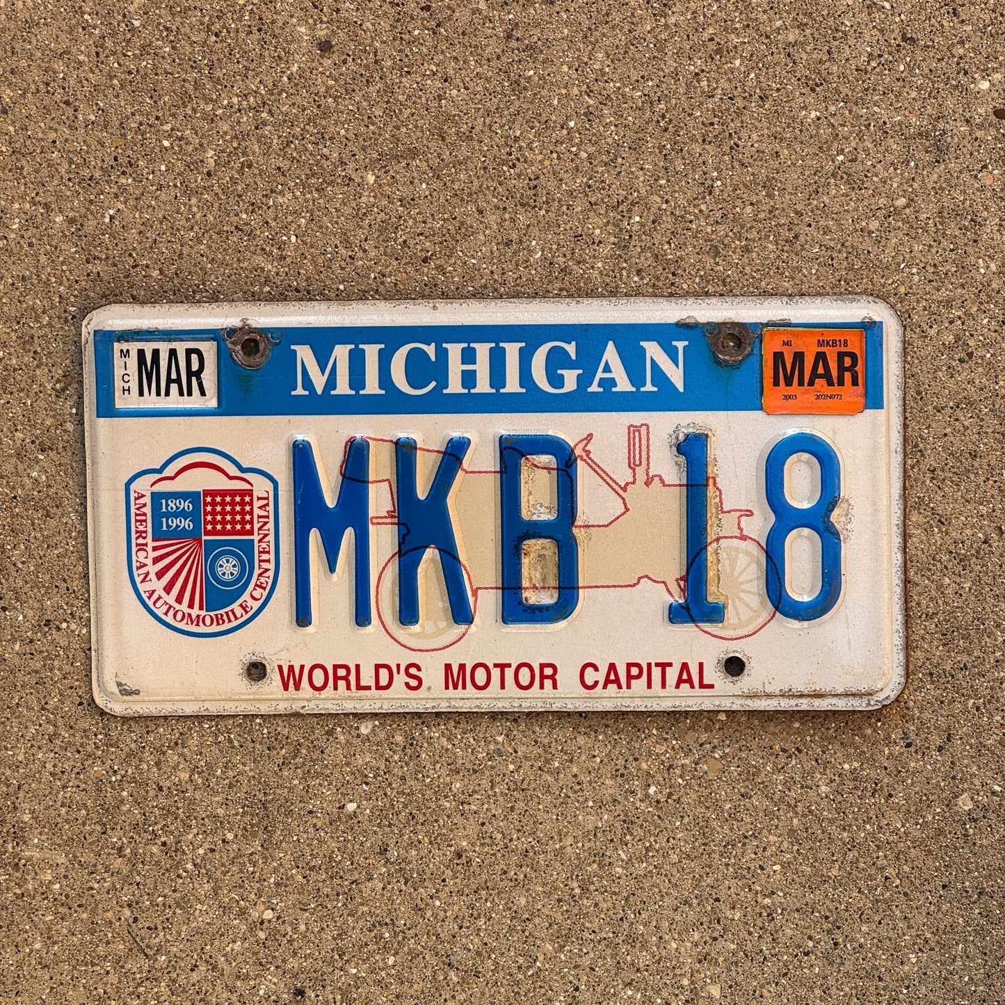 Photo of a 1996 2003 Michigan Graphic / Specialty License Plate Auto Tag Garage Decor Vintage World's Motor Capital MKB 18