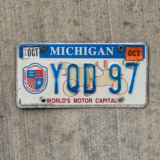 Photo of a 1996 2003 Michigan Graphic / Specialty License Plate Auto Tag Garage Decor Vintage World's Motor Capital YQD 97 with original patina
