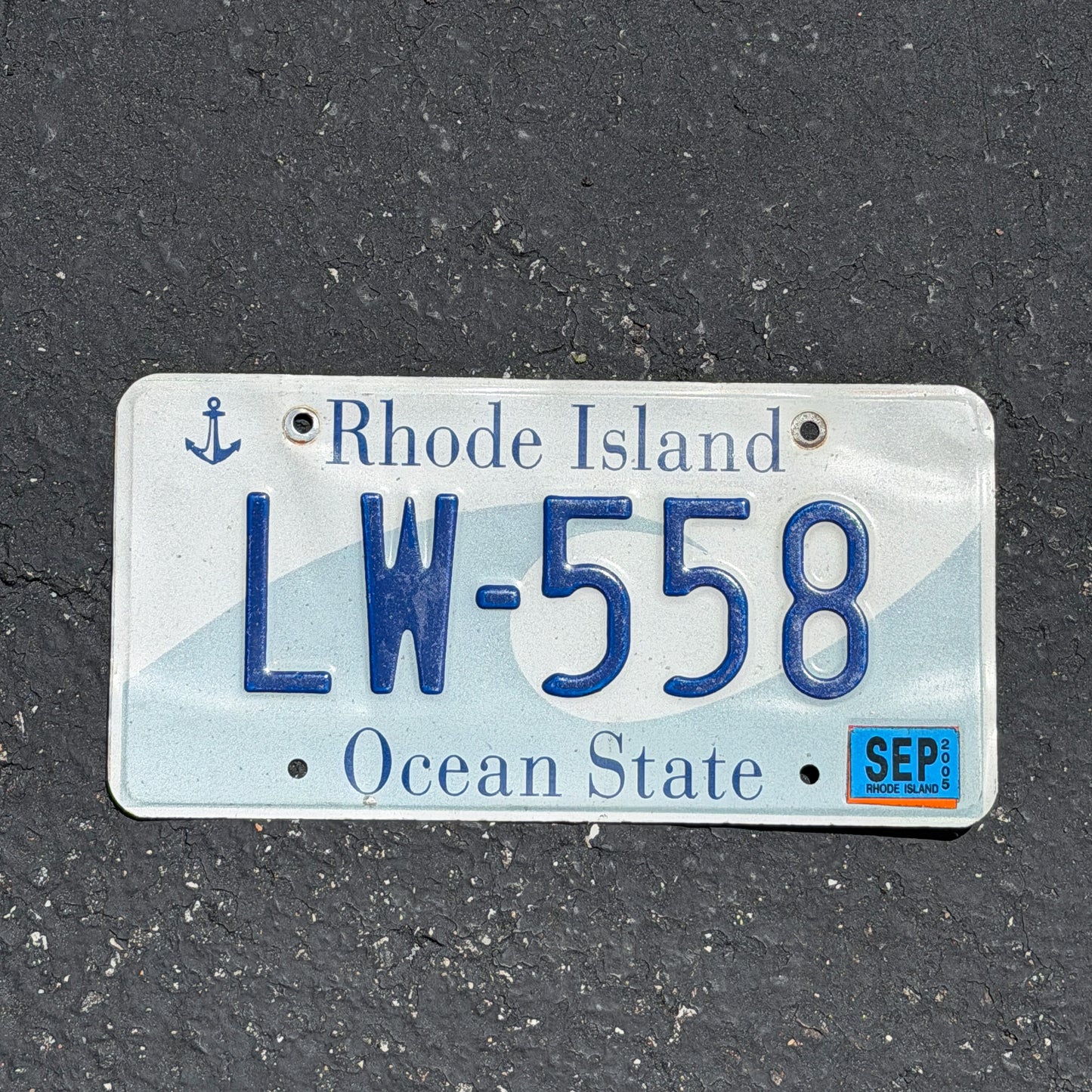 Photo of a 1996 2005 Rhode Island License Plate Auto Tag Garage Decor Vintage Wave LW 558 with original patina