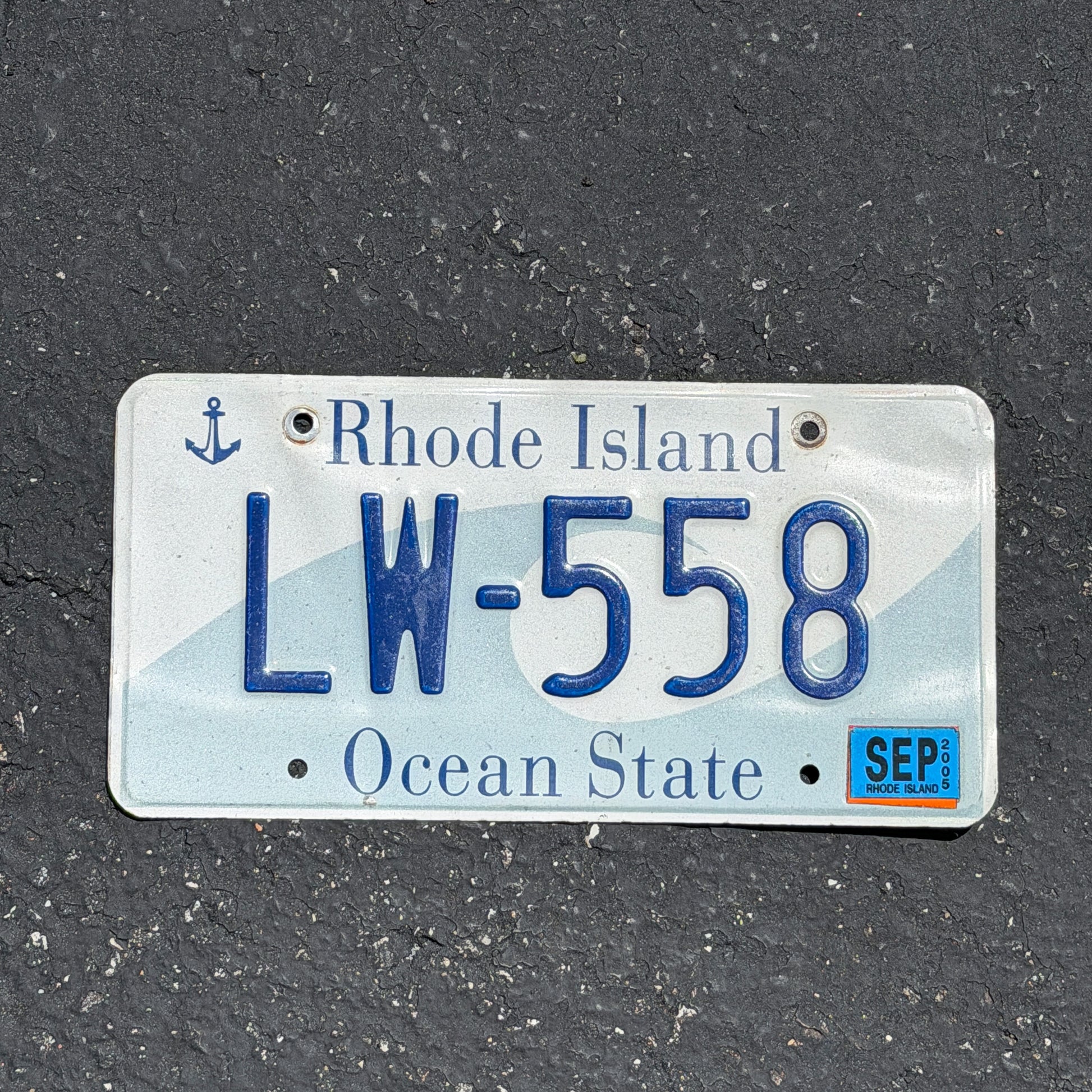 Photo of a 1996 2005 Rhode Island License Plate Auto Tag Garage Decor Vintage Wave LW 558 with original patina