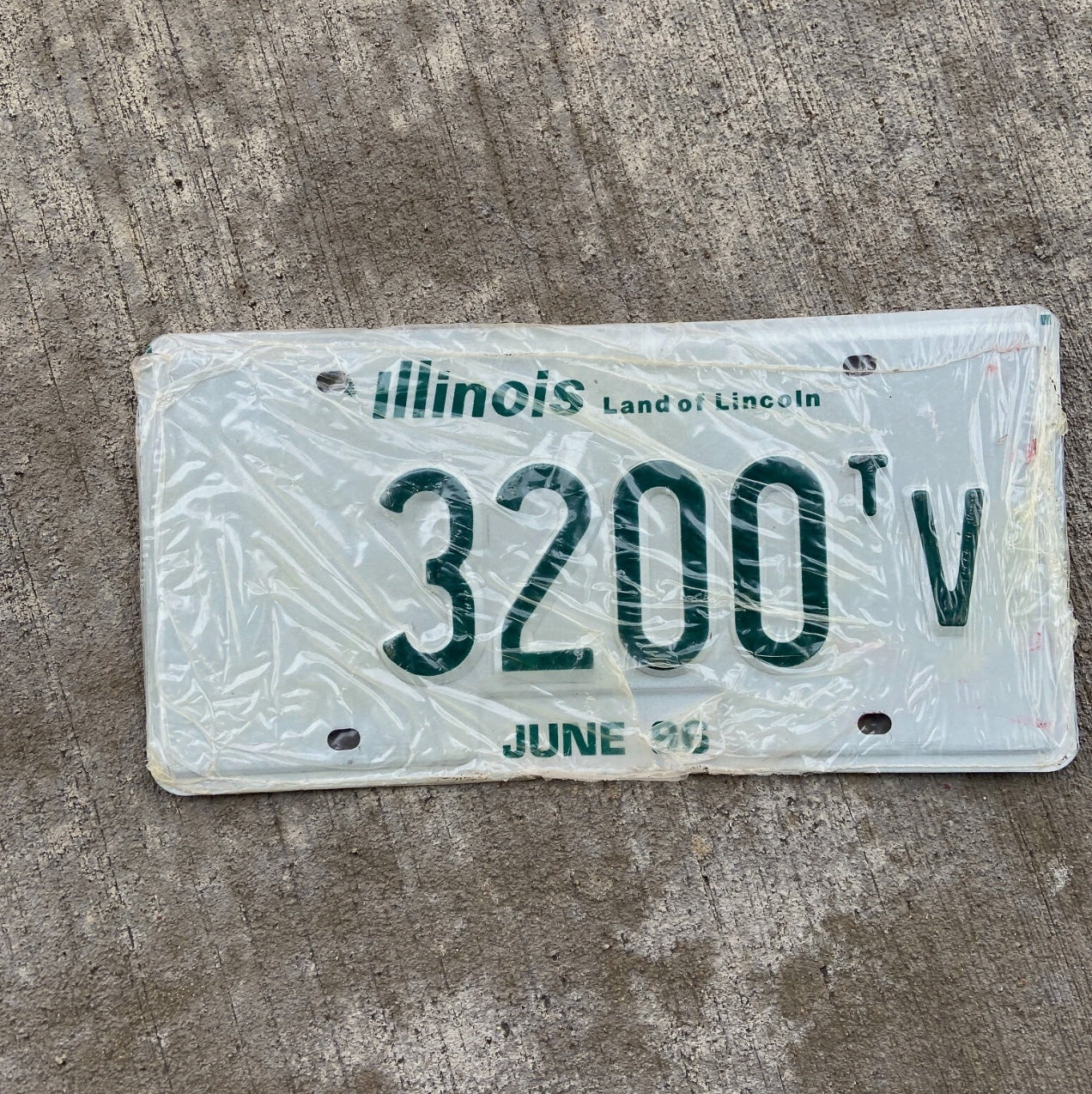 Photo of a 1996 Illinois Truck Tractor License Plate Auto Tag Garage Decor Vintage New Old Stock 3200 TV with original patina