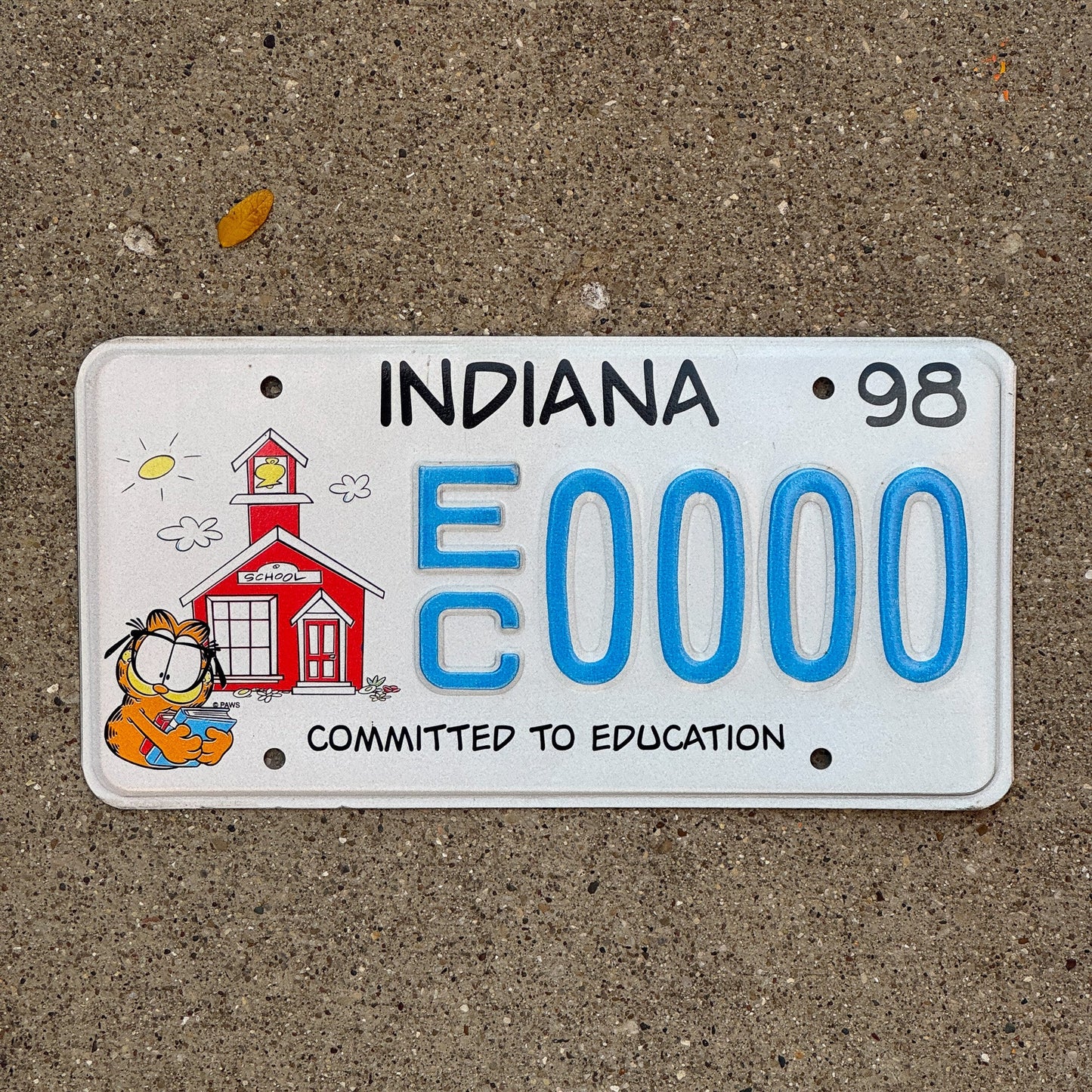 Photo of a 1997 1998 Indiana Graphic Sample License Plate Auto Tag Garage Decor Vintage Education EC 0000 with original patina