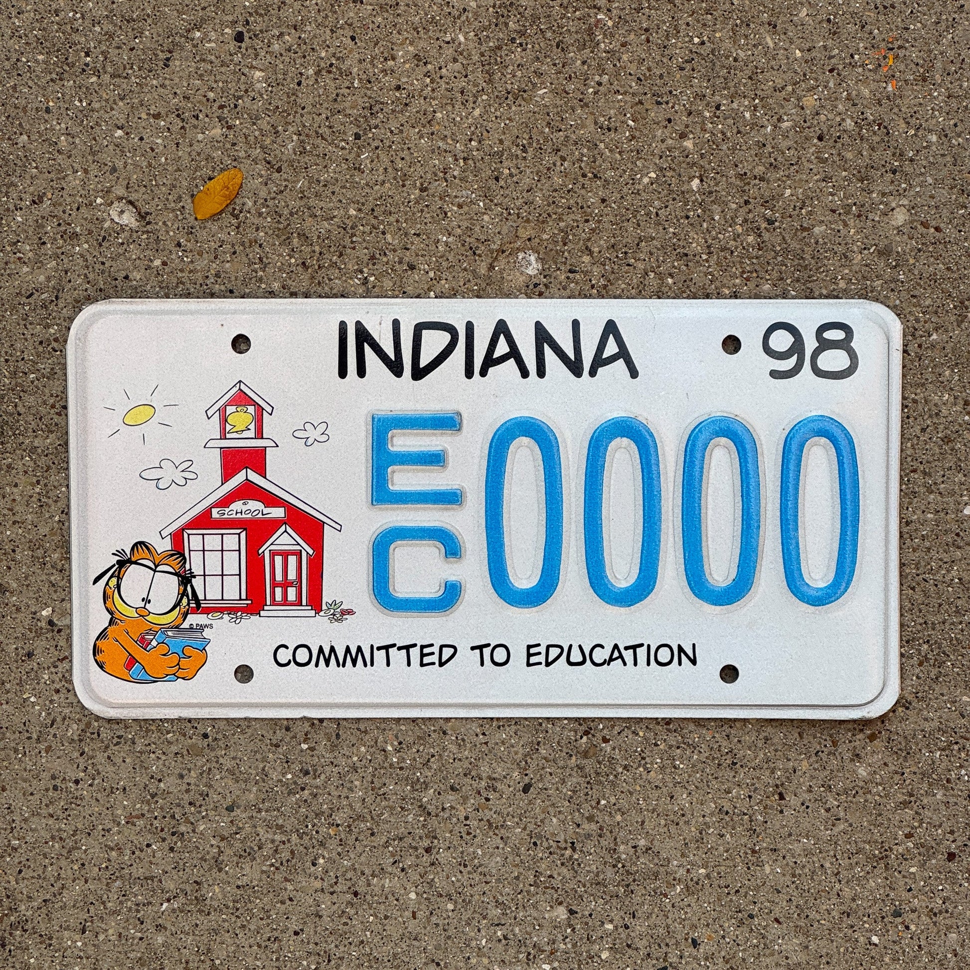 Photo of a 1997 1998 Indiana Graphic Sample License Plate Auto Tag Garage Decor Vintage Education EC 0000 with original patina