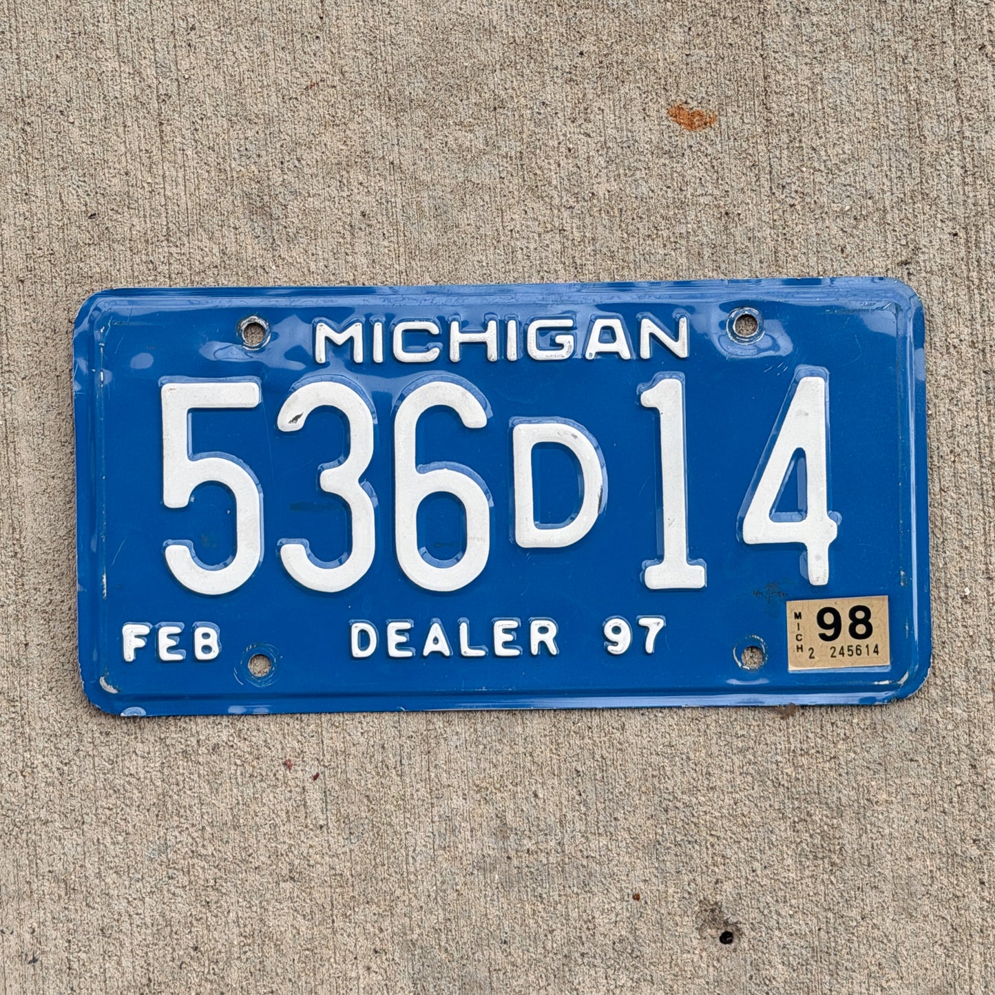 Photo of a 1997 1998 Michigan Dealer License Plate Auto Tag Garage Decor Vintage 536 D 14 with original patina