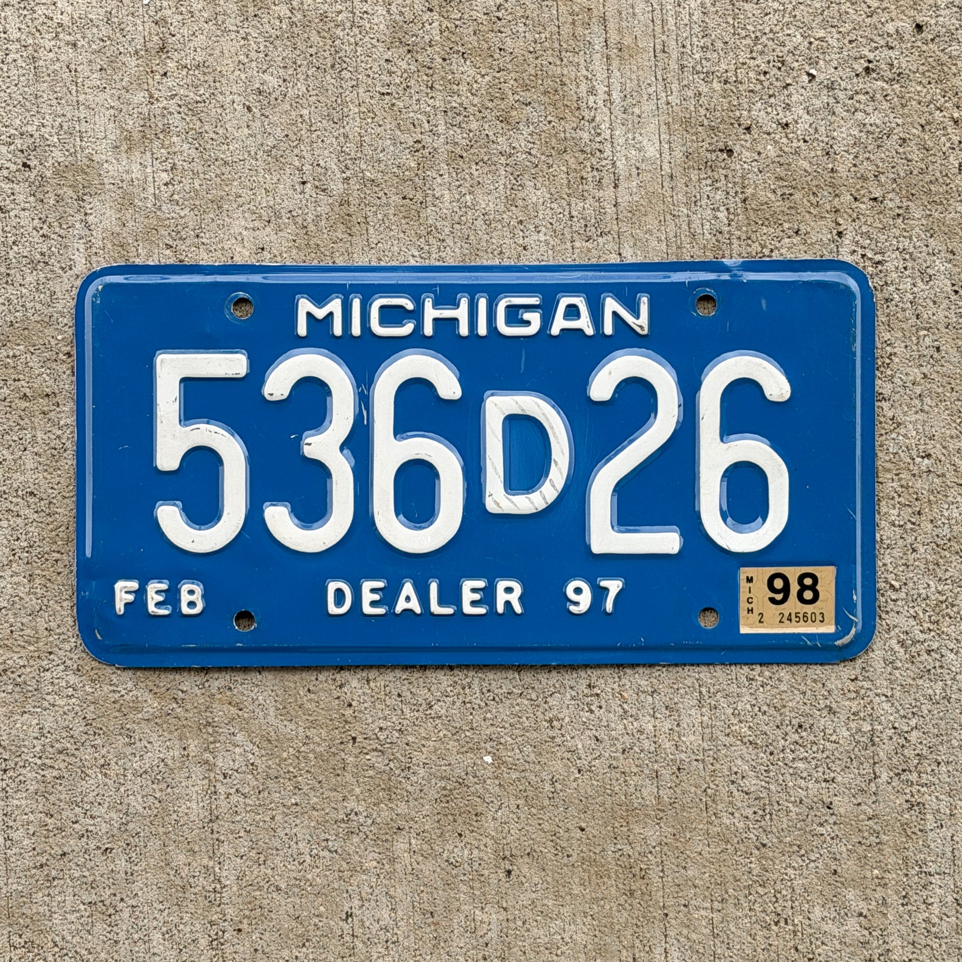 Photo of a 1997 1998 Michigan Dealer License Plate Auto Tag Garage Decor Vintage 536 D 26 with original patina