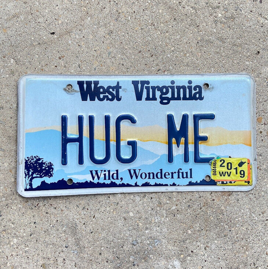Photo of a 1997 2019 West Virginia Graphic Vanity License Plate Auto Tag Garage Decor Vintage Love Anniversary Valentine's Gift HUG ME with original patina