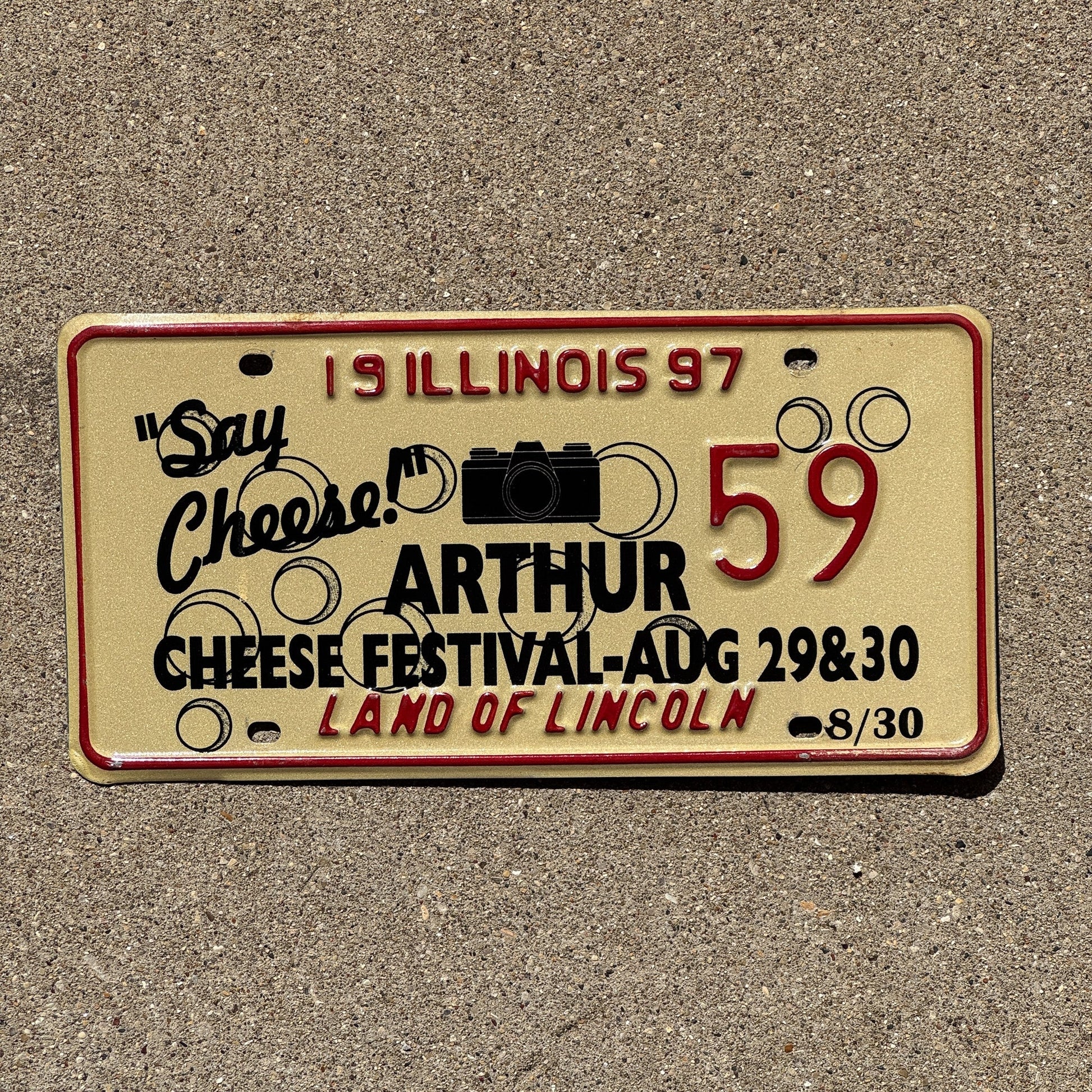 Photo of a 1997 Illinois EVENT License Plate Auto Tag 2 Garage Decor Vintage Say Cheese Festival Camera Arthur 59