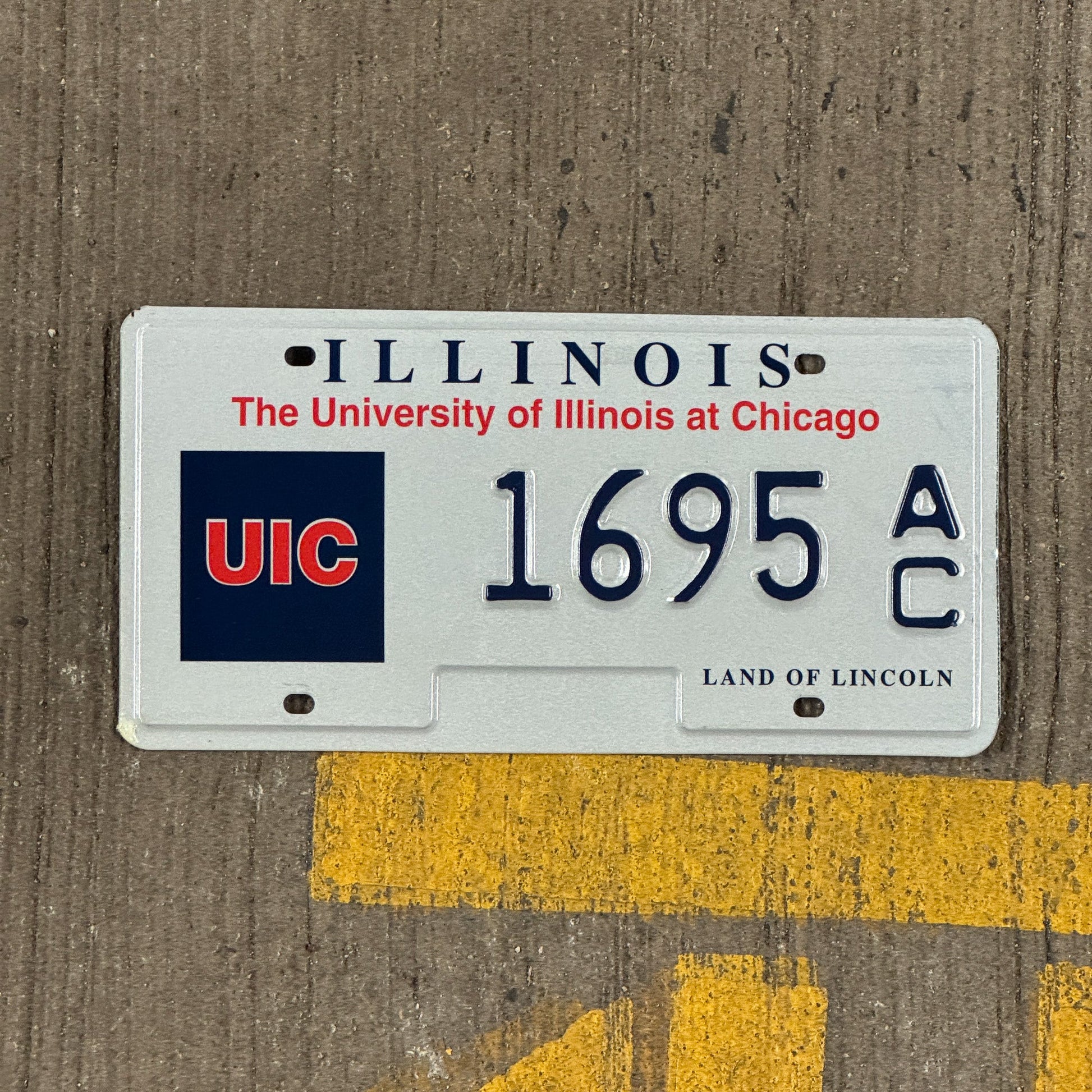 Photo of a 1997 Illinois University Of Illinois At Chicago License Plate Auto Tag Garage Decor Vintage UIC 1695 AC