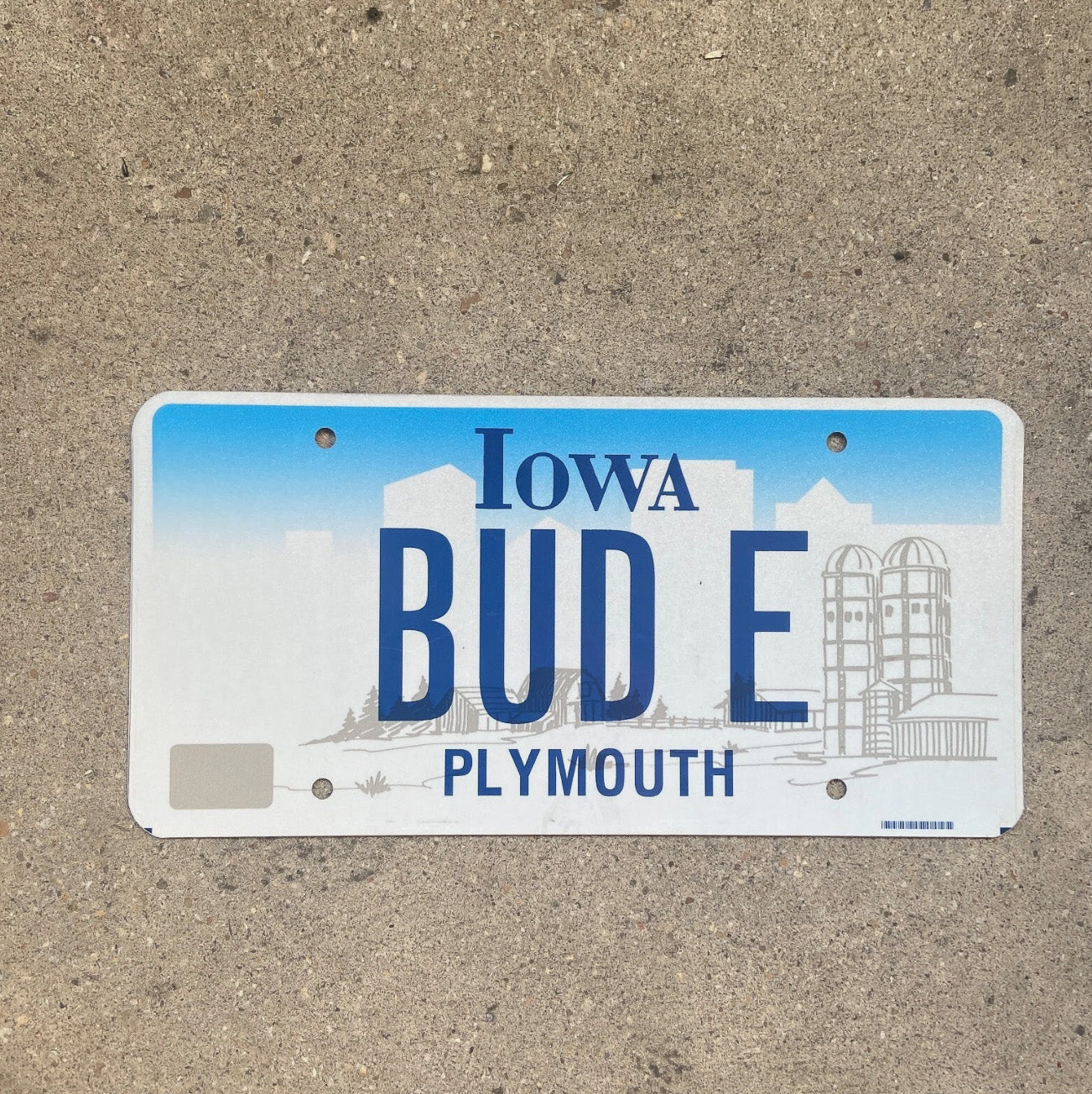 Photo of a 1997 Iowa Vanity License Plate Auto Tag Garage Decor Vintage Weed Smoke Buddy BUD E with original patina