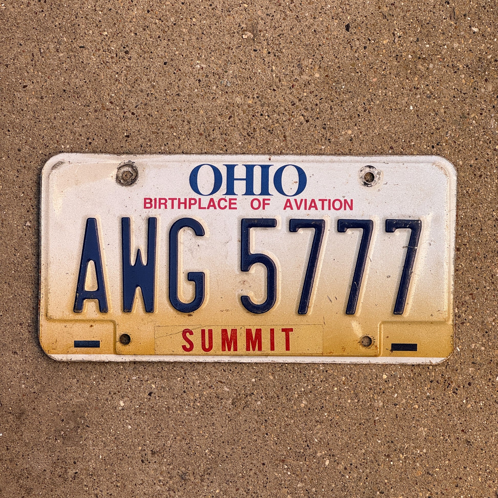 Photo of a 1997 Ohio License Plate Auto Tag Garage Decor Vintage Lucky 7 Repeat Repeating AWG 5777 with original patina