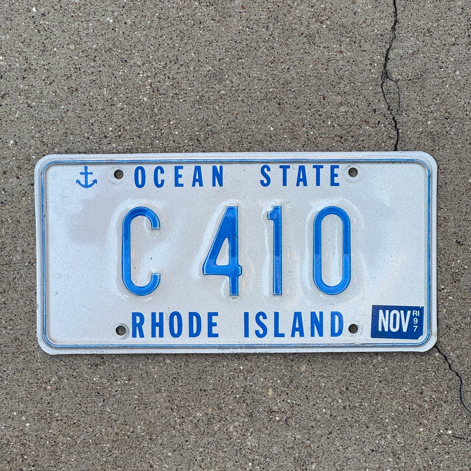 Photo of a 1997 Rhode Island Reserved Series License Plate Auto Tag Garage Decor Vintage Low Number C 410
