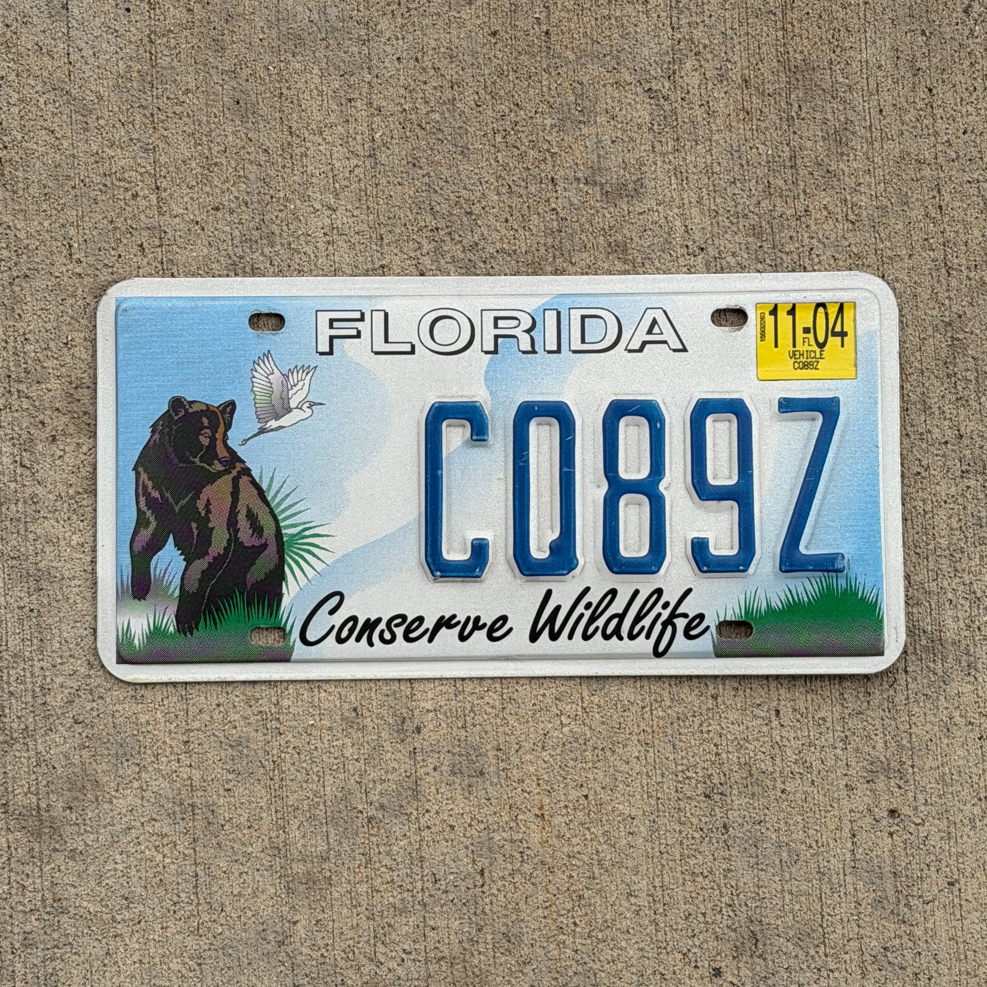 Photo of a 1998 2004 Florida License Plate Auto Tag Garage Decor Vintage Conserve Wildlife Bear CQ 89Z with original patina