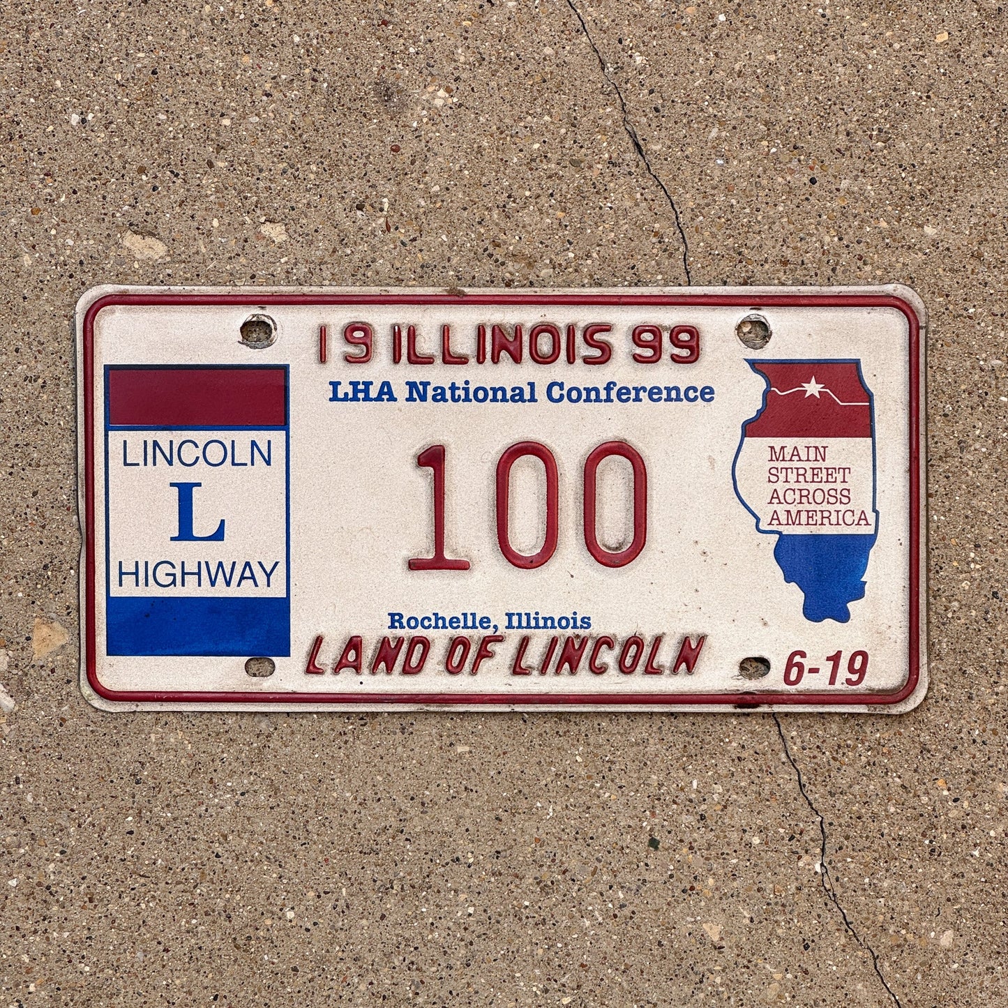 Photo of a 1999 Illinois Event License Plate Auto Tag Garage Decor Vintage Lincoln Highway 100 with original patina