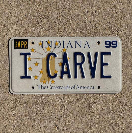 Photo of a 1999 Indiana Vanity License Plate Auto Tag Garage Decor Vintage Woodcarving Snowboarding I CARVE with original patina