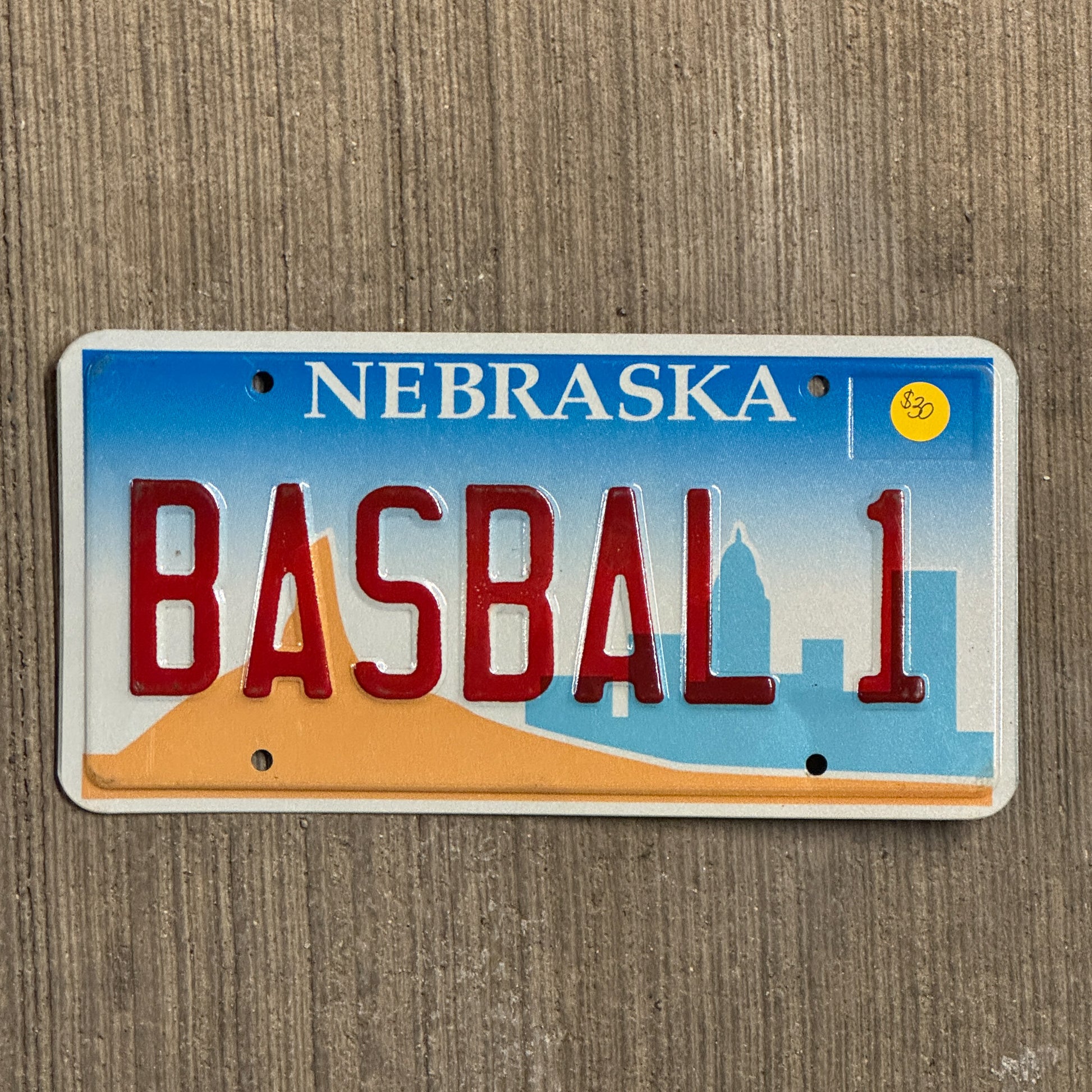 Photo of a 1999 Nebraska Vanity License Plate Auto Tag Garage Decor Vintage Baseball MLB BASBAL1 with original patina
