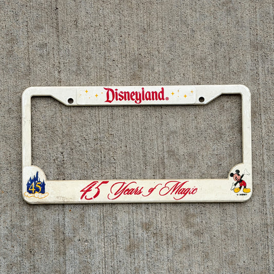 Photo of a 2000 Disneyland 45 Years of Magic California License Plate Frame Auto Tag Garage Decor Vintage
 Disney Fan Mickey Mouse Plastic with original patina
