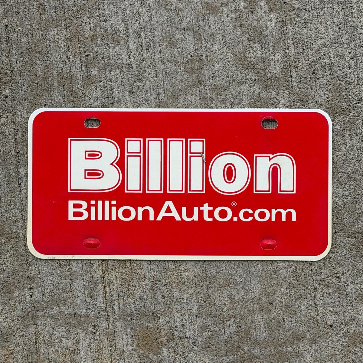 Photo of a 2000 Era Billion Auto Booster License Plate Auto Tag Garage Decor Vintage Plastic with original patina
