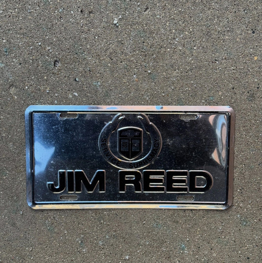 Photo of a 2000 Era Booster License Plate Auto Tag Garage Decor Vintage Jim Reed Chevy Dealer Service