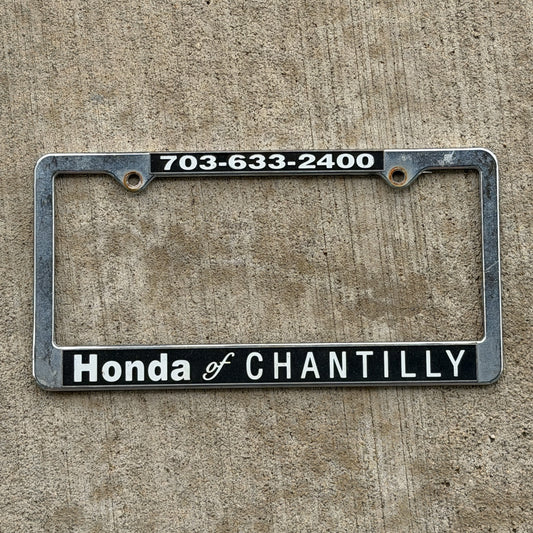 Photo of a 2000 Era Chantilly Virginia License Plate Frame Auto Tag Garage Decor Vintage
 Honda Plastic with original patina
