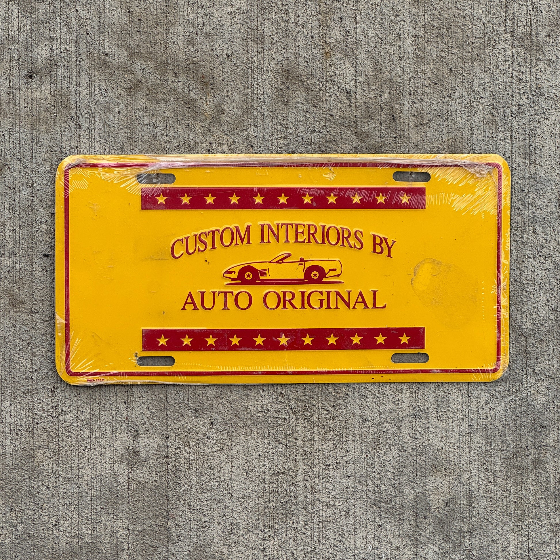 Photo of a 2000 Era Custom Interiors by Auto Original Booster License Plate Auto Tag Garage Decor Vintage Metal with original patina