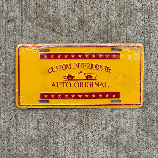 Photo of a 2000 Era Custom Interiors by Auto Original Booster License Plate Auto Tag Garage Decor Vintage Metal with original patina