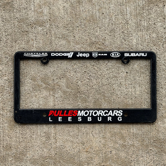 Photo of a 2000 Era Dulles Motorcars Leesburg Virginia License Plate Frame Auto Tag Garage Decor Vintage
 Chrysler Dodge Jeep Ram Kia Subaru Plastic with original patina