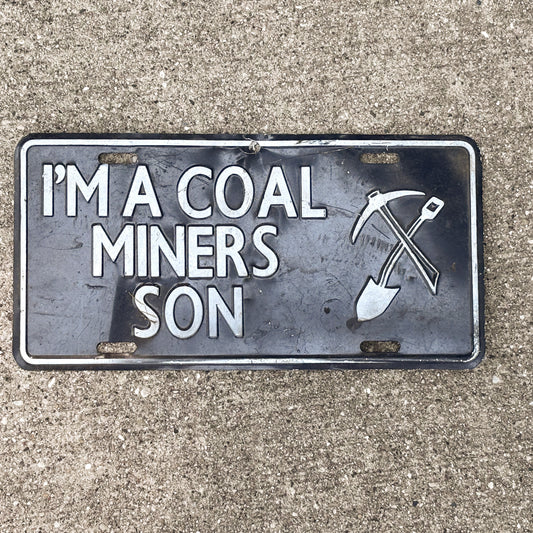 Photo of a 2000 Era I'm a Coal Miner's Son Booster License Plate Auto Tag Garage Decor Vintage
 Metal with original patina