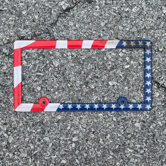 Photo of a 2000 Era License Plate Frame Auto Tag Garage Decor Vintage Plastic USA American Flag