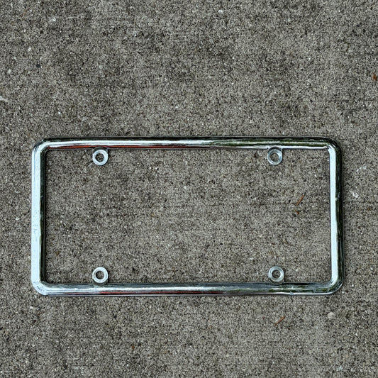 Photo of a 2000 Era Metal Chrome License Plate Frame Auto Tag Garage Decor Vintage
 with original patina
