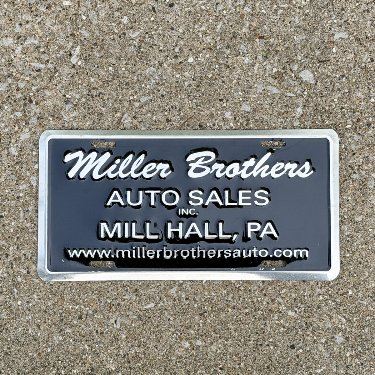 Photo of a 2000 Era Mill Hall Pennsylvania Booster License Plate Auto Tag Garage Decor Vintage Miller Brothers Auto Sales Millers with original patina
