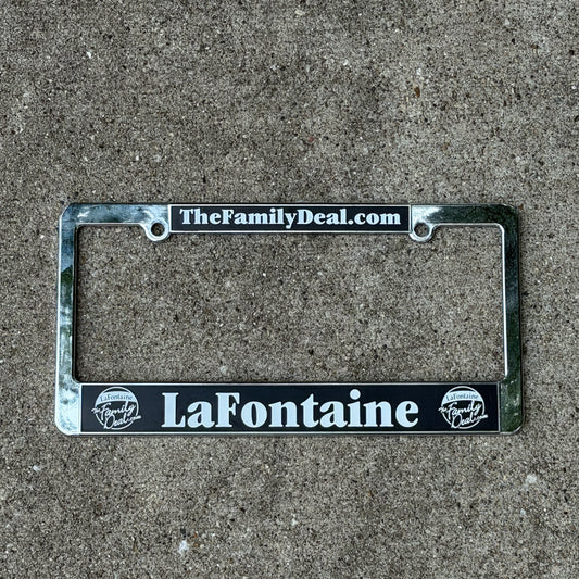 Photo of a 2000 Era TheFamilyDeal LaFontaine Michigan License Plate Frame Auto Tag Garage Decor Vintage
 Dealership Plastic with original patina
