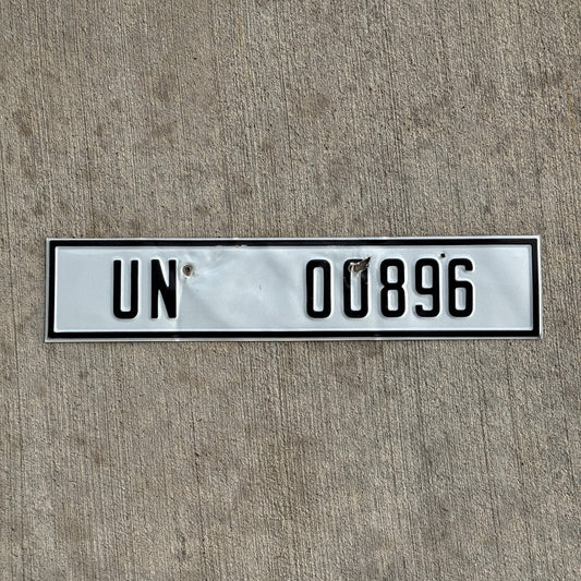 Photo of a 2000 Era United Nations License Plate Auto Tag Garage Decor Vintage UN 00896 with original patina