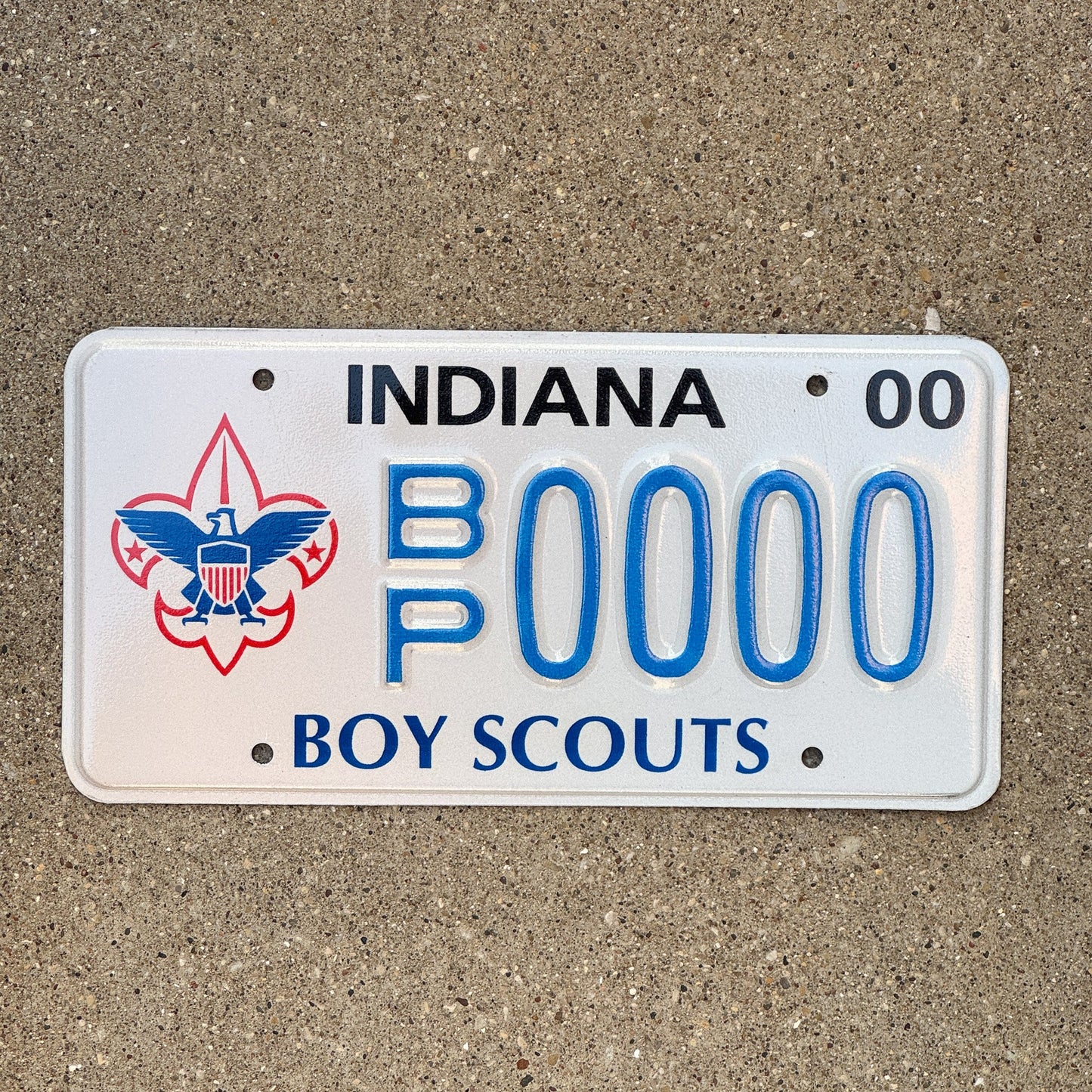 Photo of a 2000 Indiana Graphic Sample License Plate Auto Tag Garage Decor Vintage Boy Scouts BP 0000 with original patina