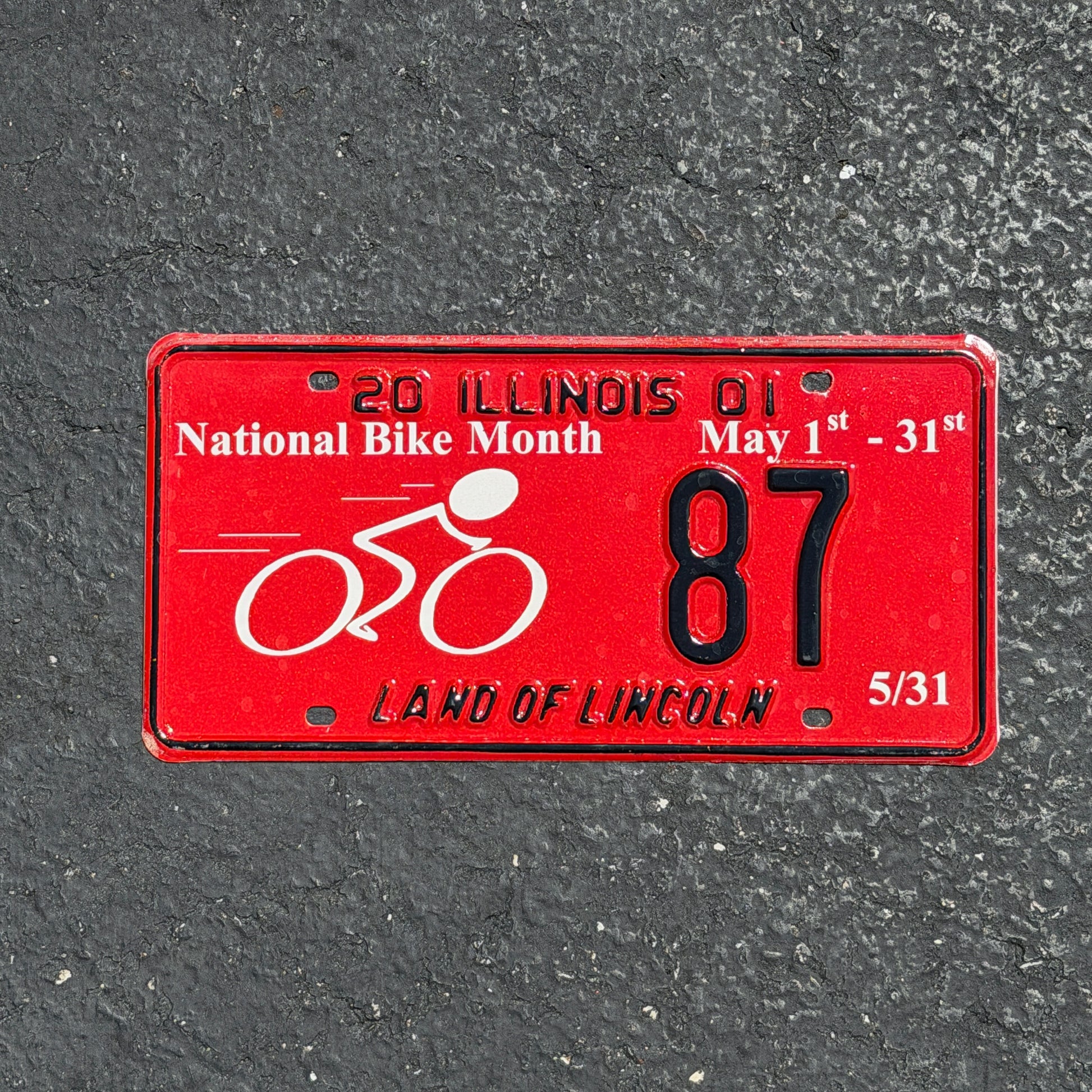Photo of a 2001 Illinois Event License Plate Auto Tag Garage Decor Vintage National Bike Month Cycling 87 with original patina