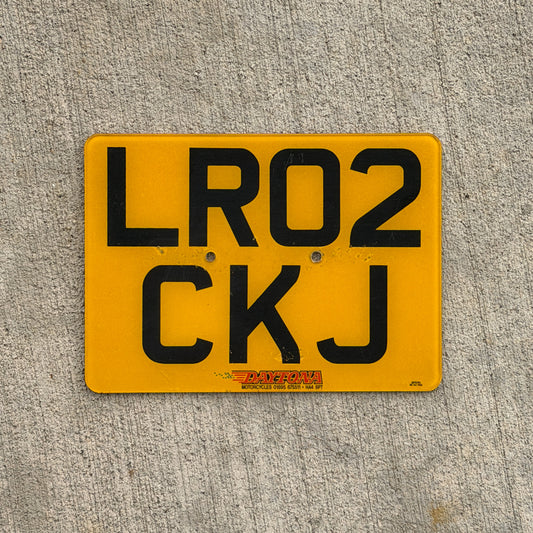 Photo of a 2002 United Kingdom Motorcycle License Plate Auto Tag Garage Decor Vintage UK England LR 02 CKJ with original patina