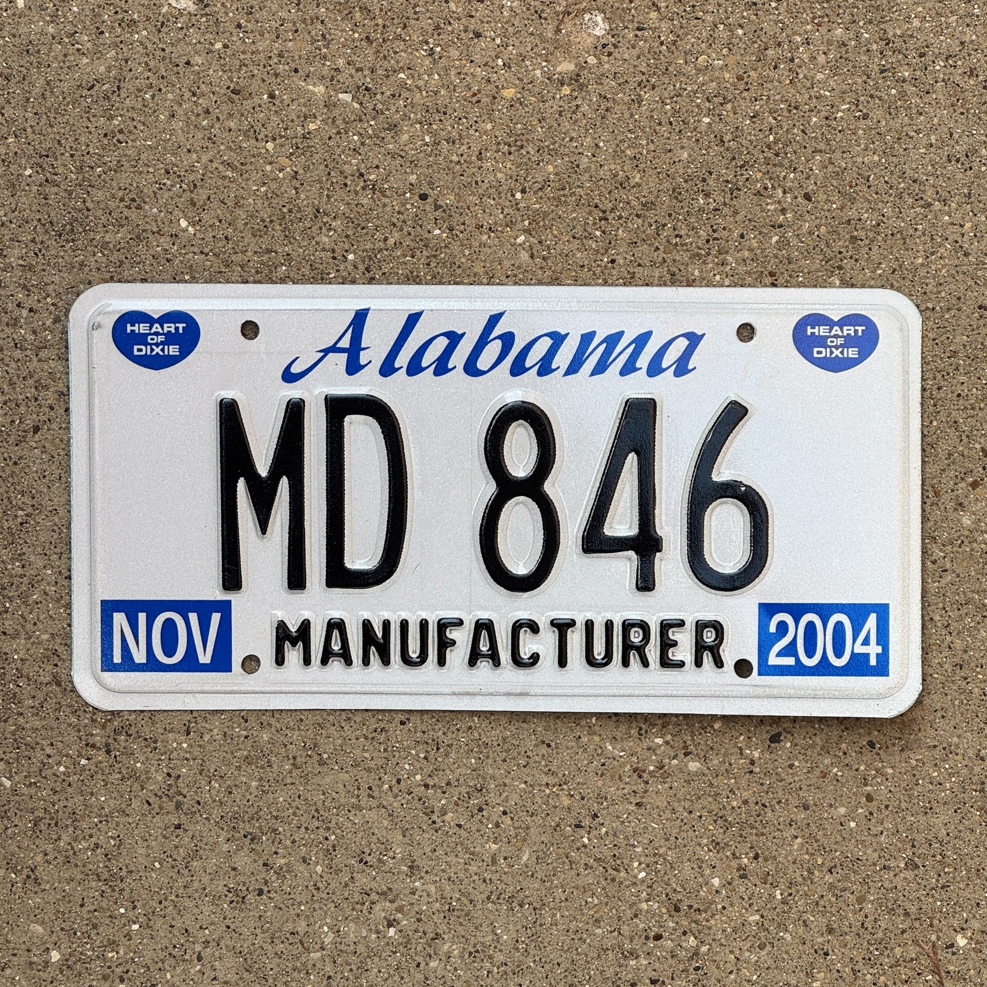 Photo of a 2004 Alabama Manufacturer License Plate Auto Tag Garage Decor Vintage MD 846 with original patina