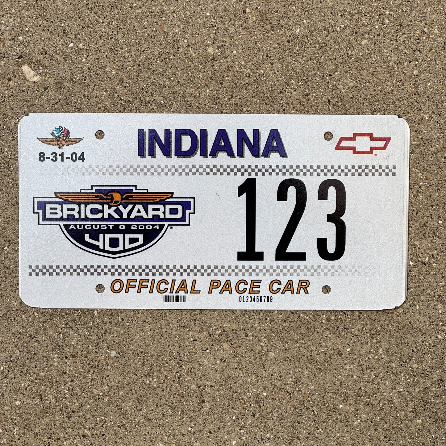 Photo of a 2004 Indiana Graphic / Specialty License Plate Auto Tag Garage Decor Vintage Brickyard 400 Official Pace Car Fun Number 123 with original patina