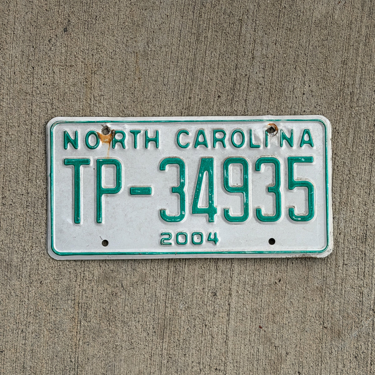 Photo of a 2004 North Carolina Transporter License Plate Auto Tag Garage Decor Vintage TP 34935 with original patina