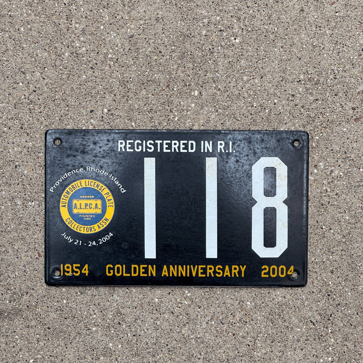 Photo of a 2004 Rhode Island Porcelain License Plate Auto Tag Garage Decor Vintage Providence ALPCA Convention 118