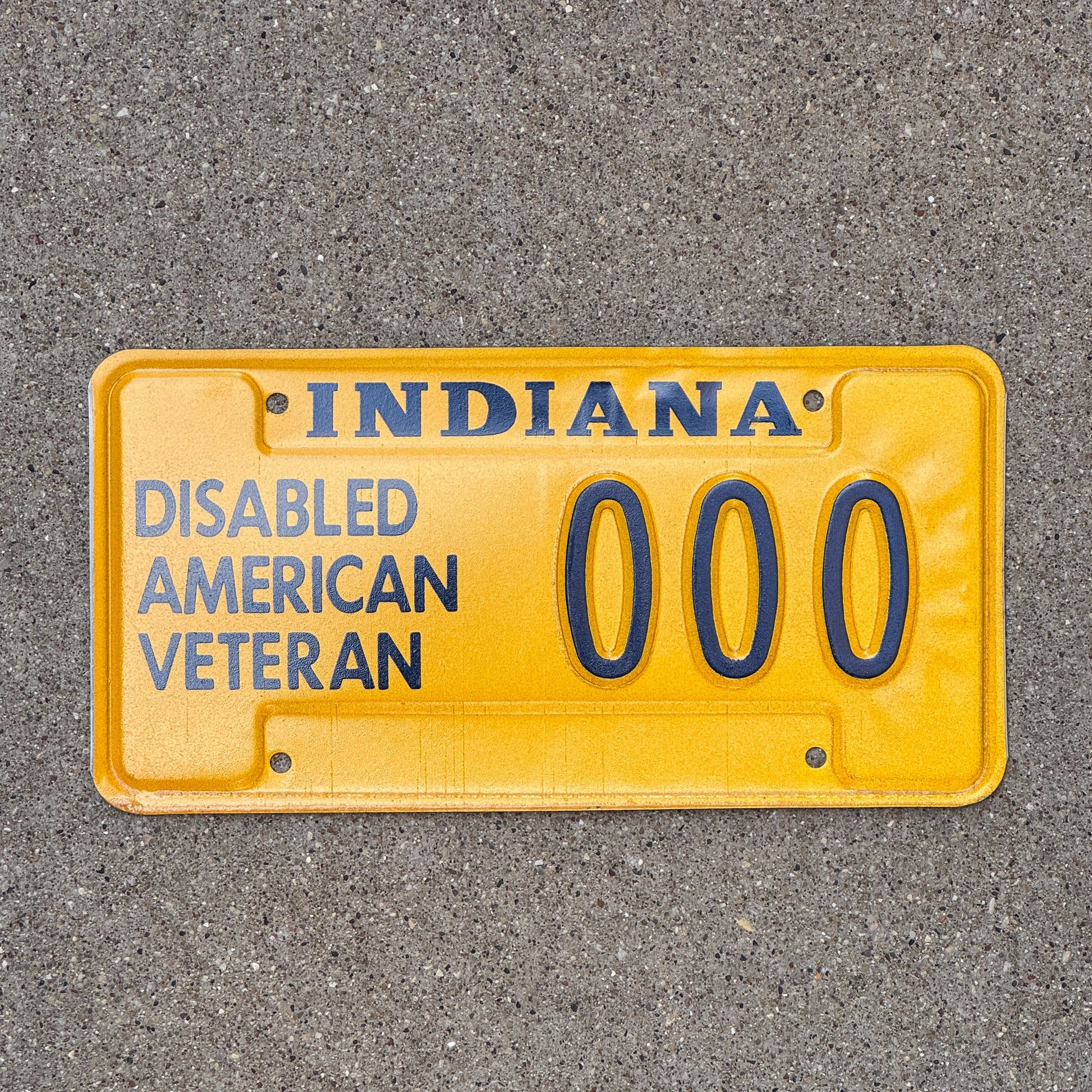 Photo of a 2006 Indiana Disabled Veteran Sample License Plate Auto Tag Garage Decor Vintage DAV 000 with original patina