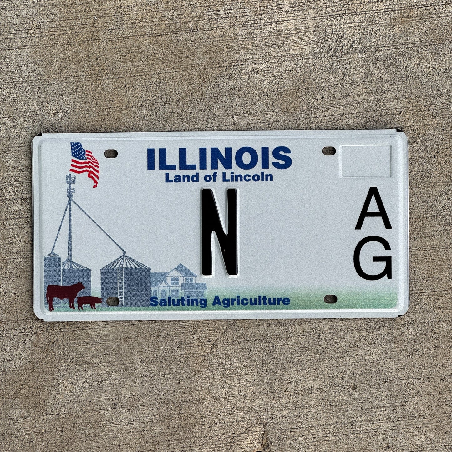 Photo of a 2010 Illinois Graphic / Specialty License Plate Auto Tag Garage Decor Vintage Saluting Agriculture Low Number Single Letter N with original patina