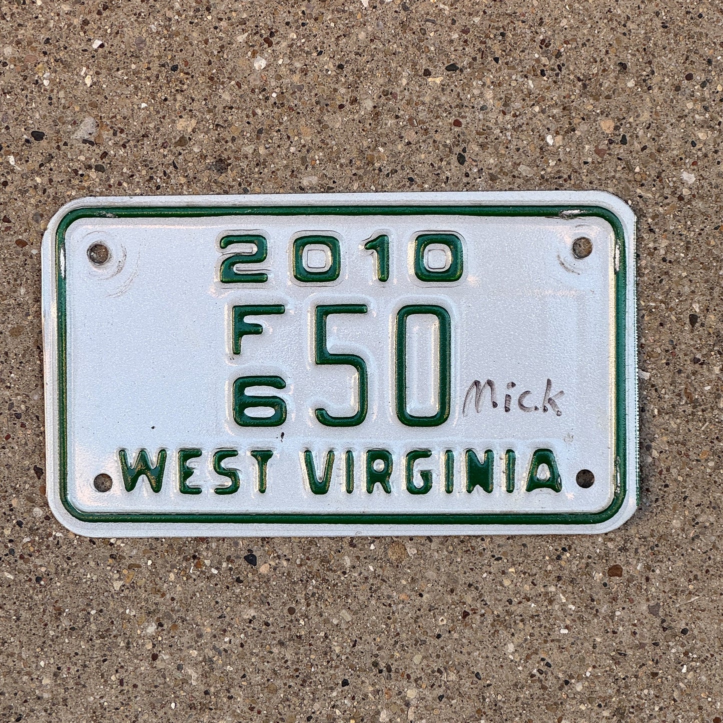 Photo of a 2010 West Virginia Motorcycle Dealer License Plate Auto Tag Garage Decor Vintage F6 50 with original patina