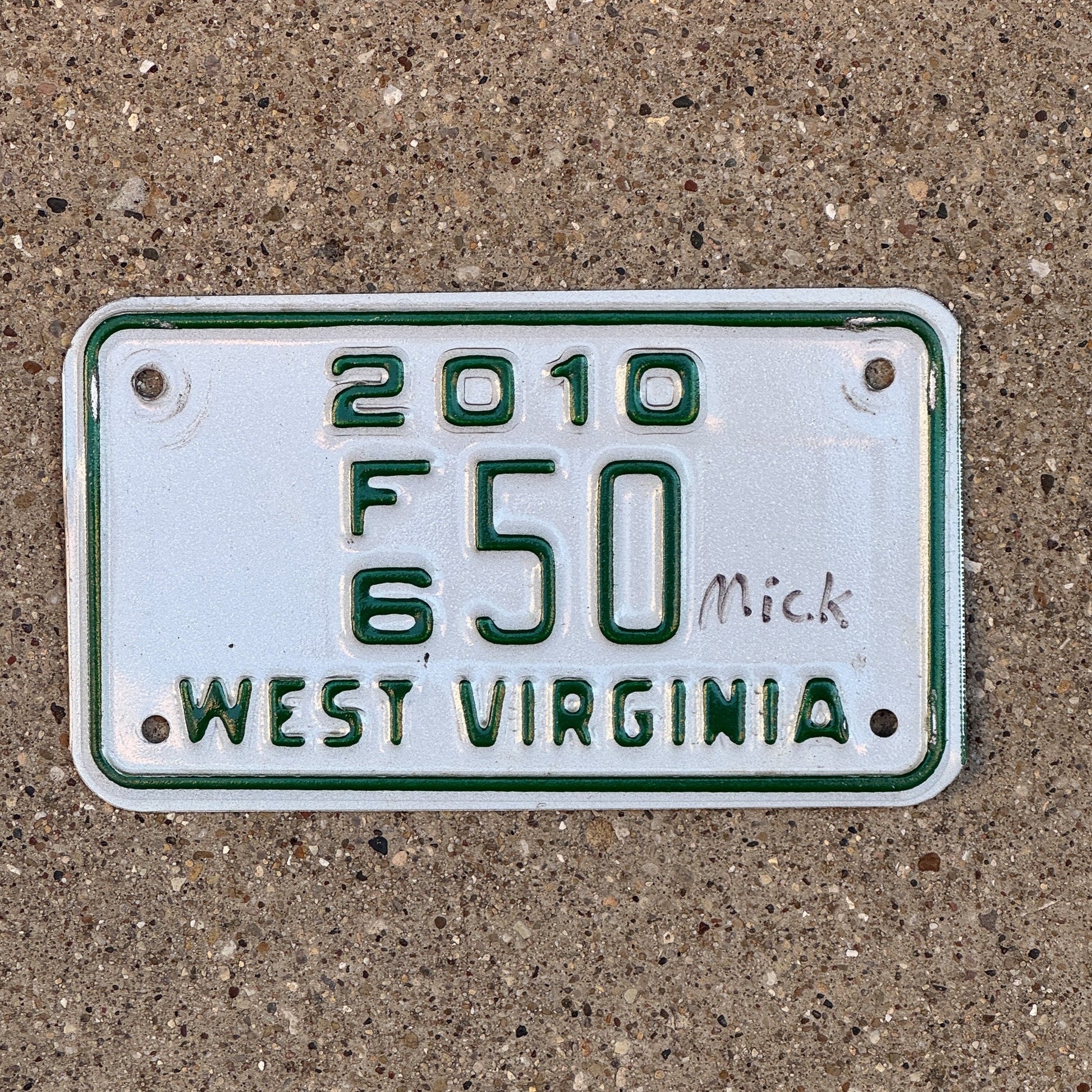 Photo of a 2010 West Virginia Motorcycle Dealer License Plate Auto Tag Garage Decor Vintage F6 50 with original patina