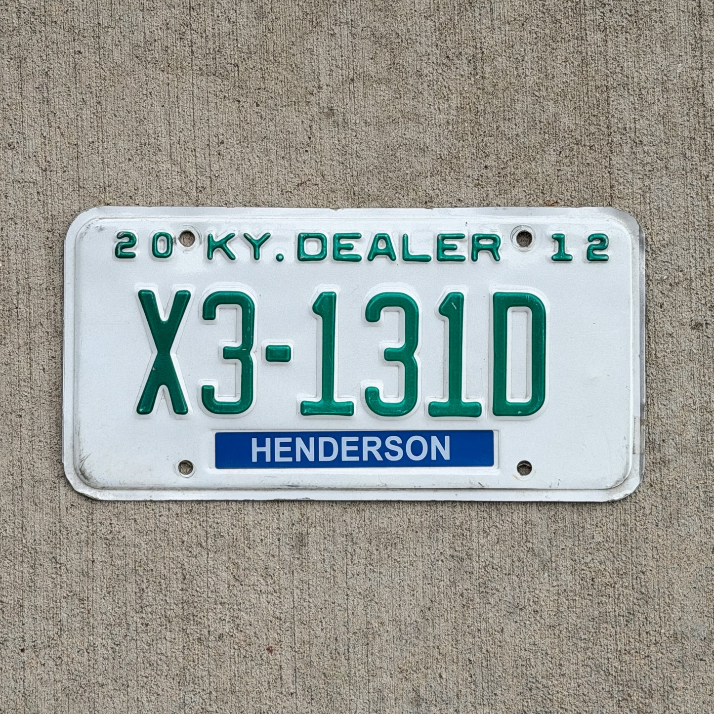 Photo of a 2012 Kentucky Dealer License Plate Auto Tag Garage Decor Vintage X3 131D with original patina