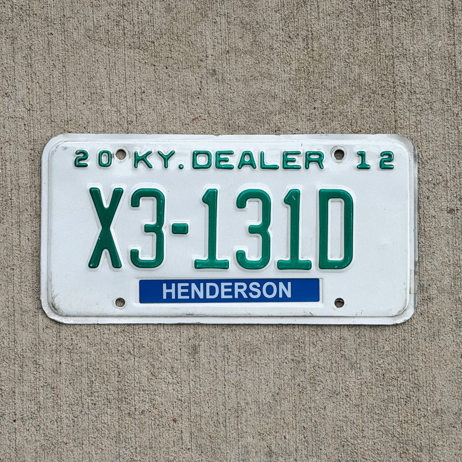 Photo of a 2012 Kentucky Dealer License Plate Auto Tag Garage Decor Vintage X3 131D with original patina