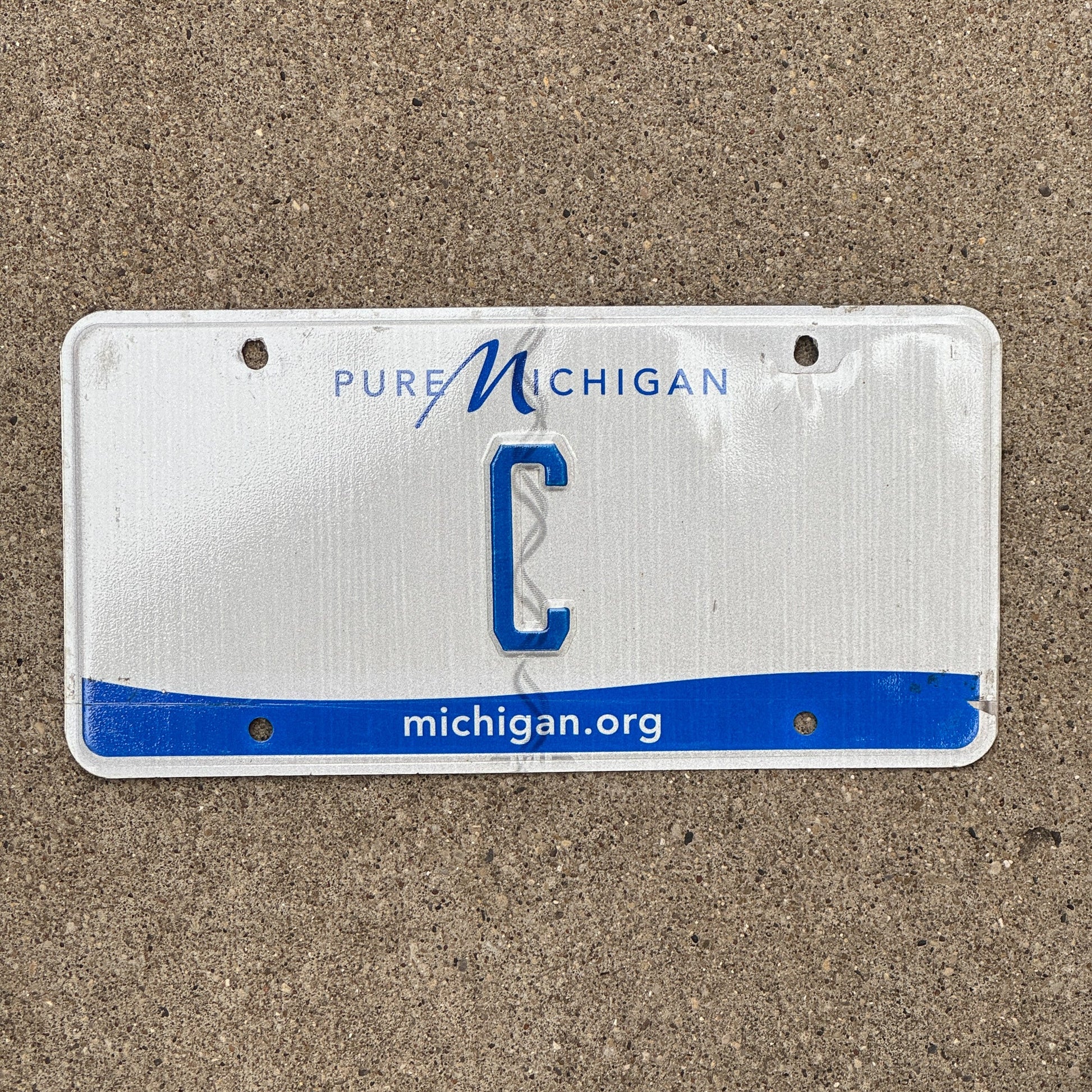 Photo of a 2013 Michigan License Plate Auto Tag Garage Decor Vintage Single Letter C with original patina