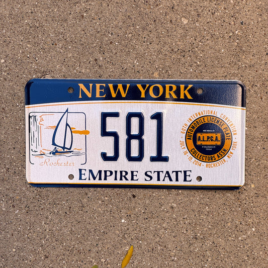 Photo of a 2014 New York Souvenir Booster License Plate Auto Tag Garage Decor Vintage Rochester ALPCA Convention 581 with original patina
