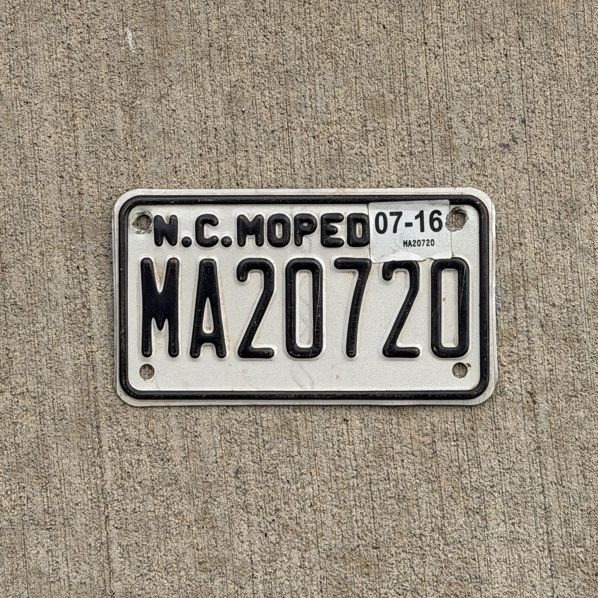 Photo of a 2015 2016 North Carolina Moped License Plate Auto Tag Garage Decor Vintage MA 20720 with original patina