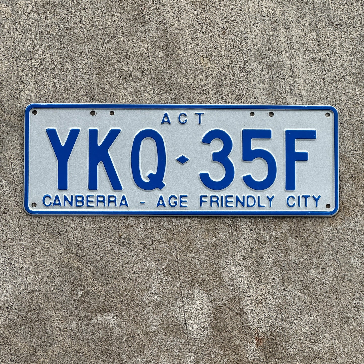 Photo of a 2015 Australian Capital Territory ACT License Plate Auto Tag Garage Decor Vintage Canberra Age Friendly City YKQ 35F with original patina