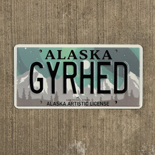 Photo of a 2019 Alaska Graphic Vanity License Plate Auto Tag 1 Vintage Garage Artistic Northern Lights Gear Head GYRHED with original patina